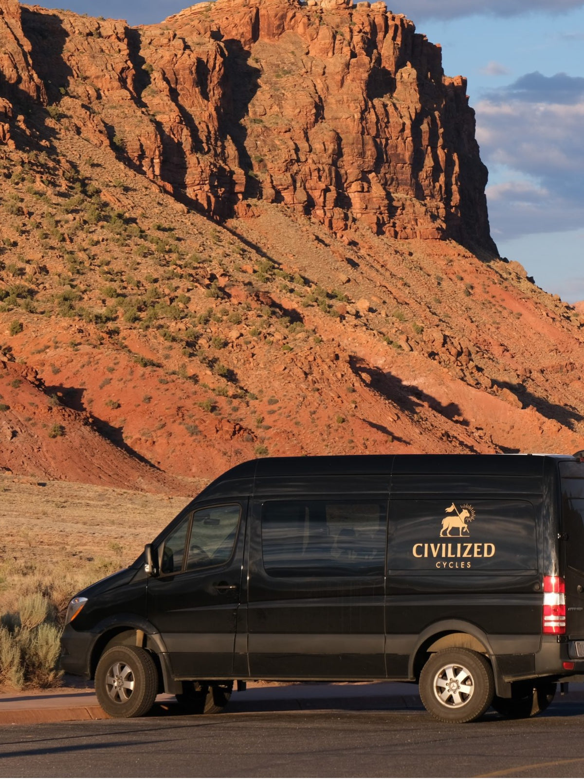 A Civ branded black van parked in the southwestern desert.